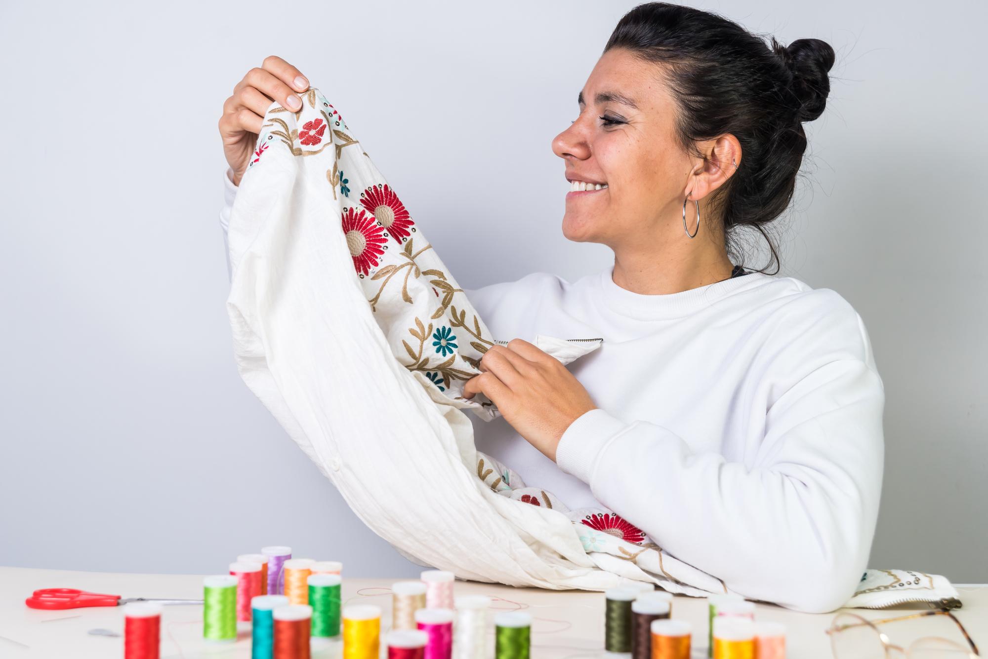 Teacher demonstrating embroidery technique to student